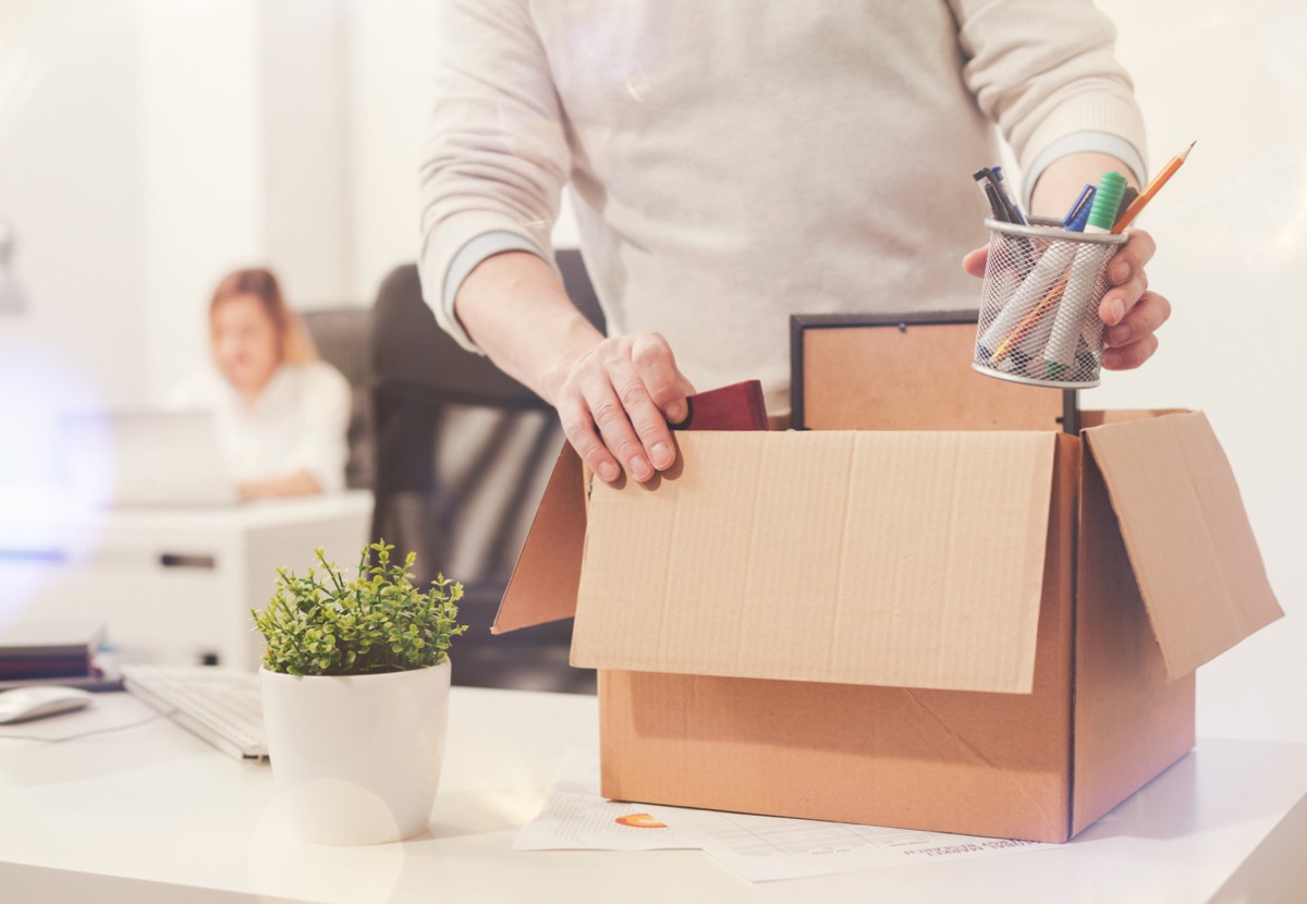 sad-dismissed-worker-taking-his-office-supplies-with-him-picture-id825175586