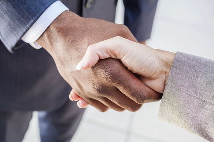 African American businessman man shaking hands with a businesswoman