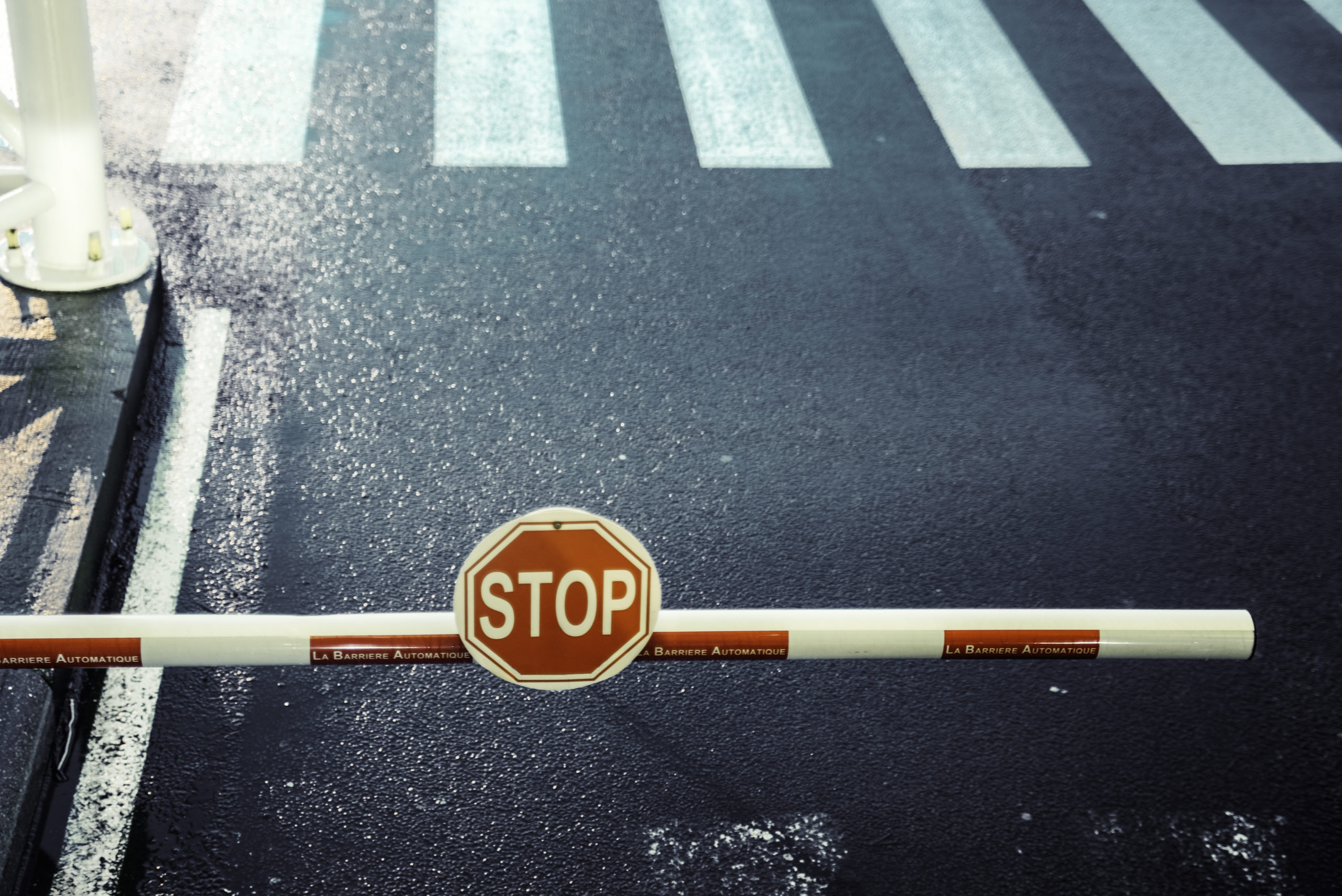 toll bar, stop sign, road, zebra crossing