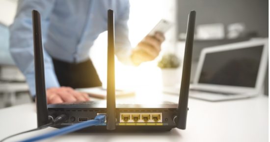 wireless-router-concept-man-using-smartphone-picture-id1131624429