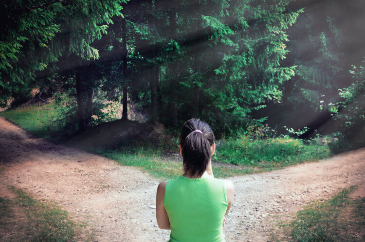 Woman with a choice near the forked road Woman with a choice near the forked road