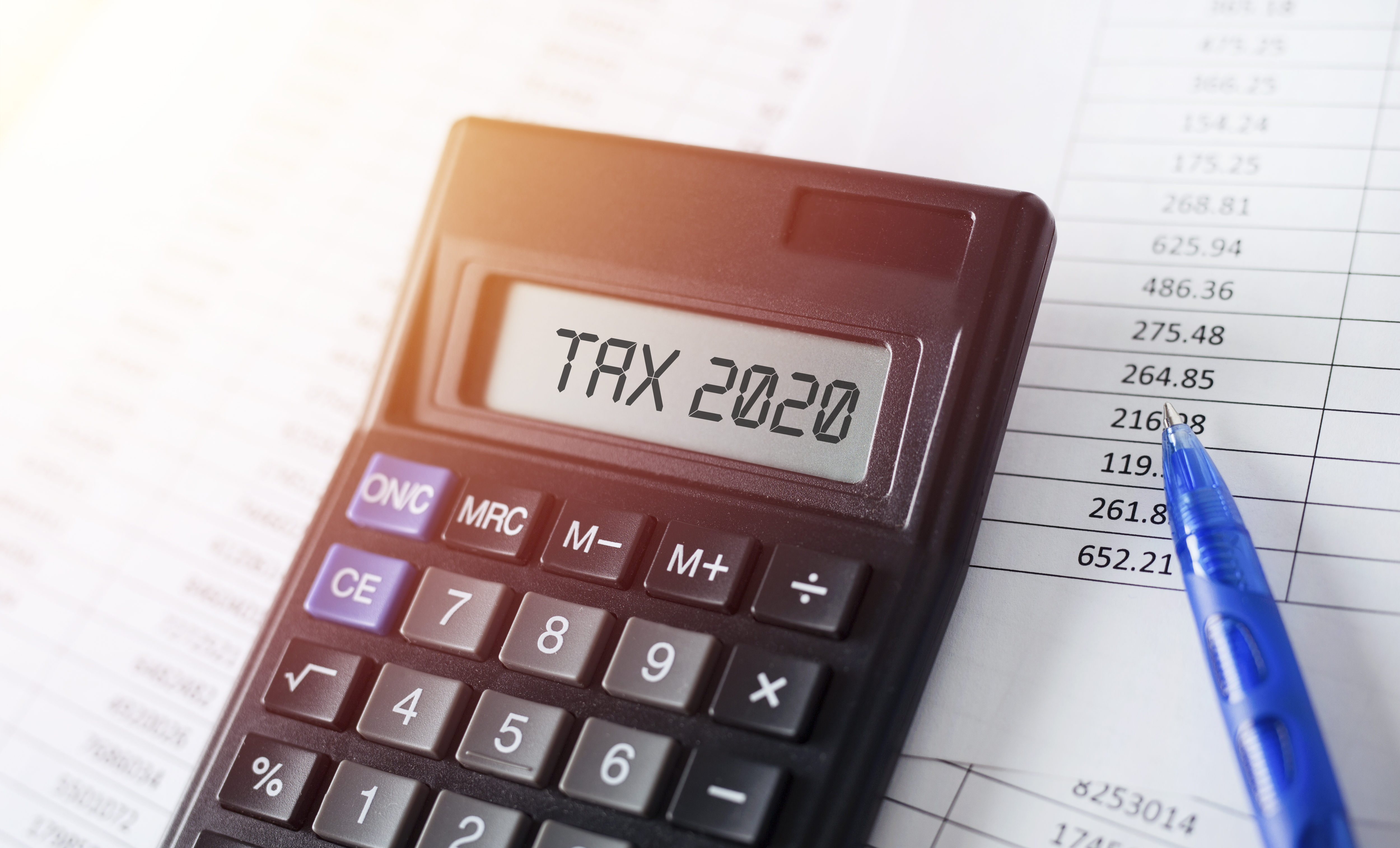 Word Tax 2020 on calculator. Business and tax concept.