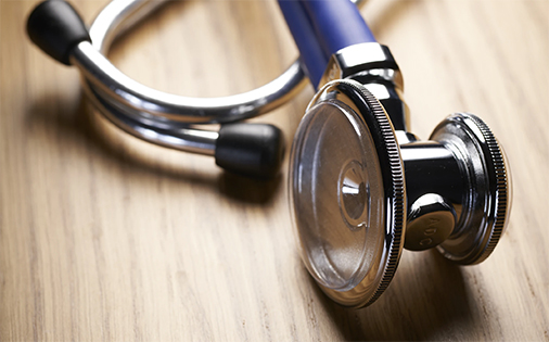 a stethoscope sitting on a wooden table; image used for blog post about medicare premium deductions