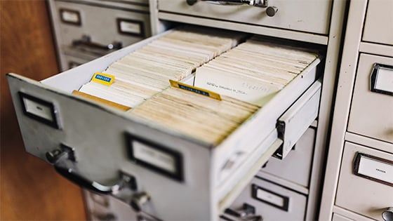 a file cabinet drawer open filled with organized file folders; image used for blog post about good recordkeeping for tax deductions and audits
