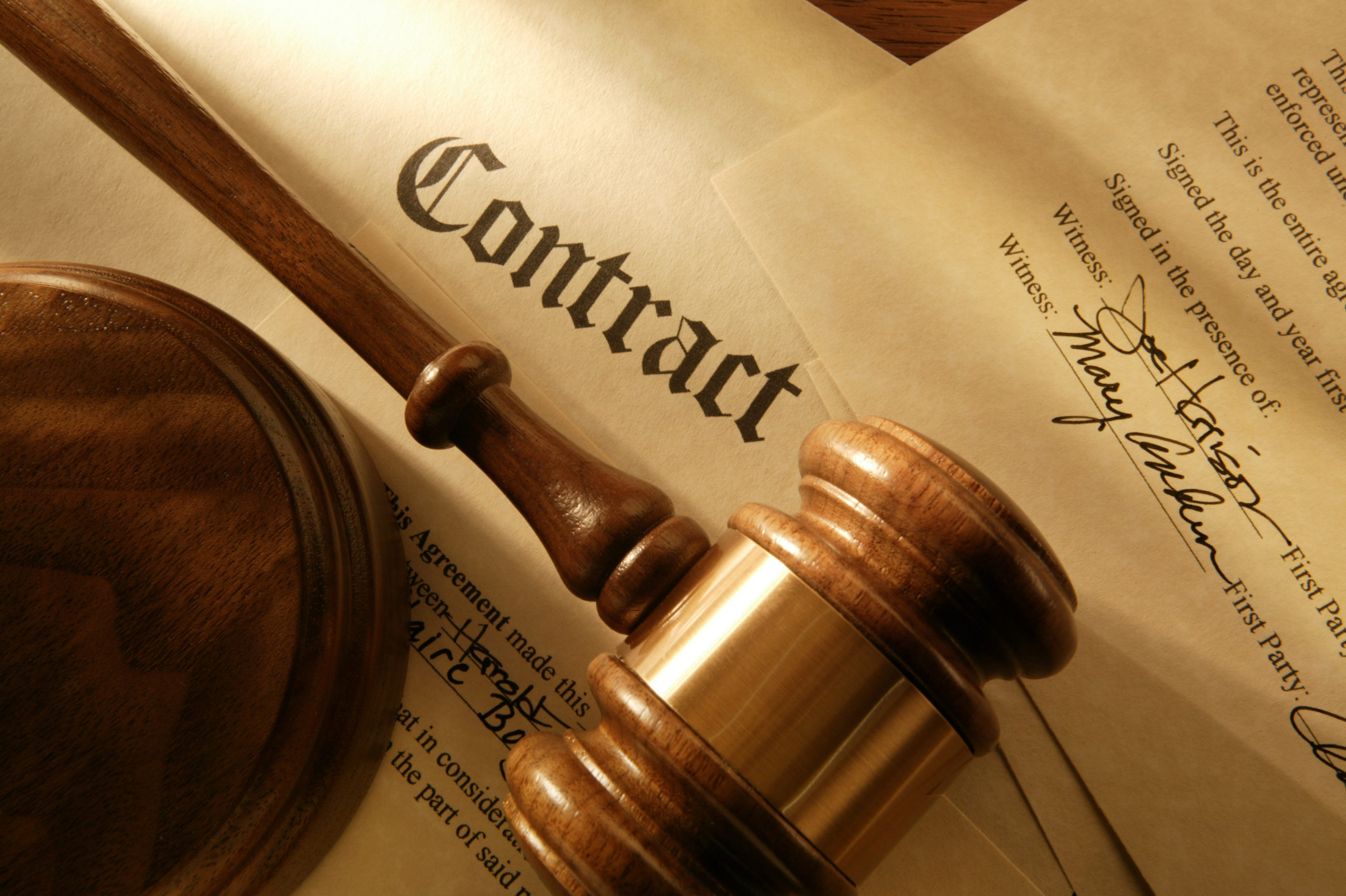 Close up of signed contract with gavel and sound block