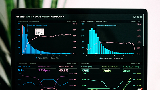 a computer screen shows data with bar graphs, metric numbers and more; image used for blog post about financial dashboards helping not-for-profit success