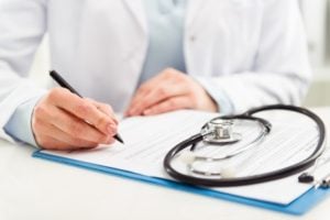 Physician working at desk with stethoscope