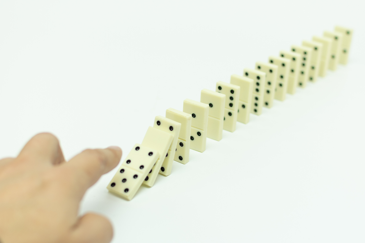 knuckles of dominoes falling one after another, pointing a finger