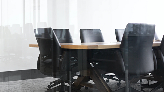 empty black office chairs sitting around a table; image used for blog post about SEC rule amendments making proxy voting advice more transparent
