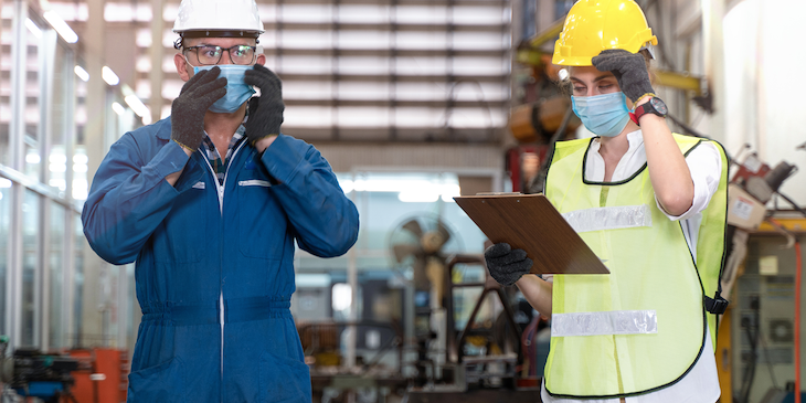 Construction workers wear masks for safety before starting work