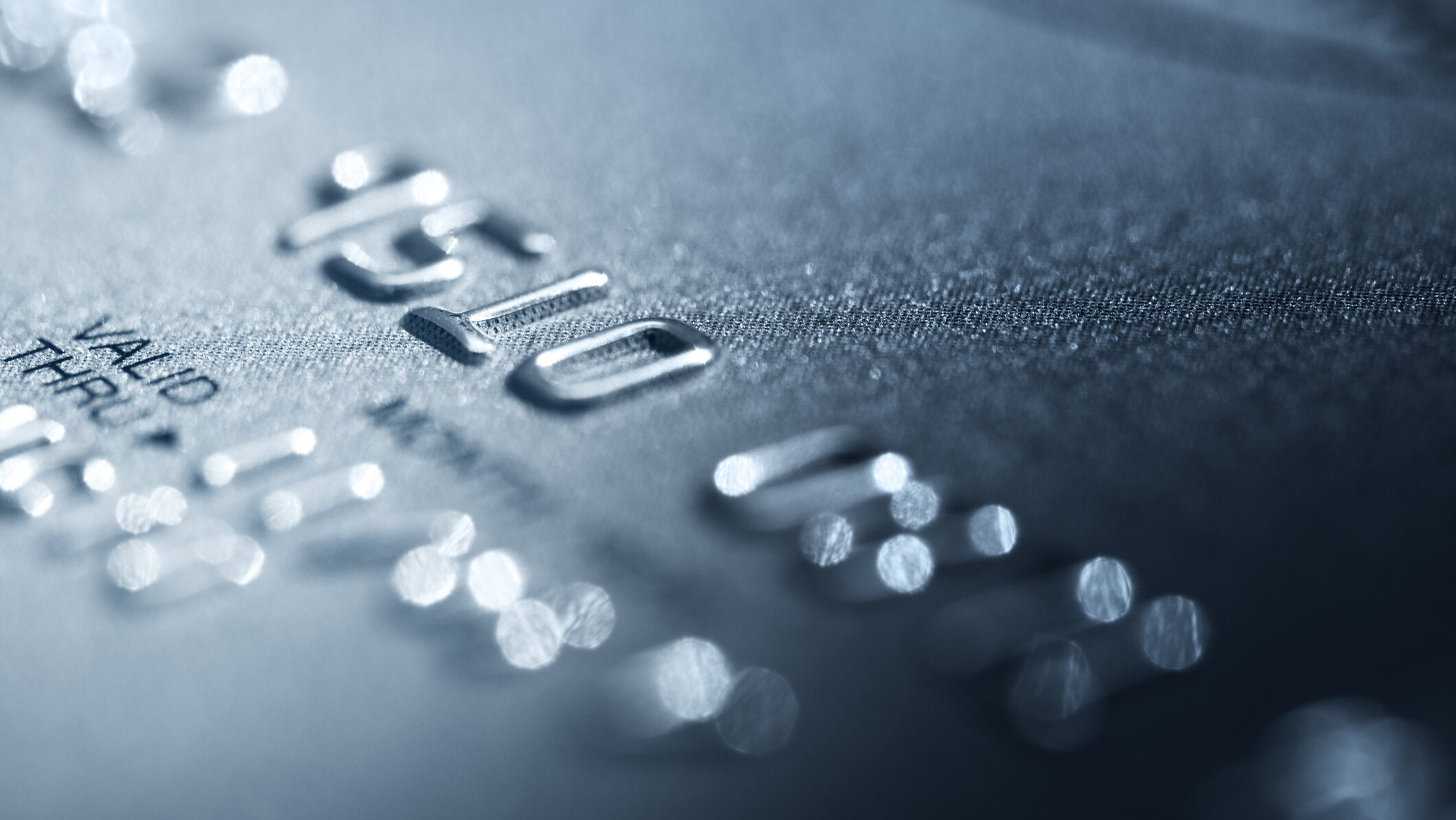 Credit card detail photo focused on raised printed numbers