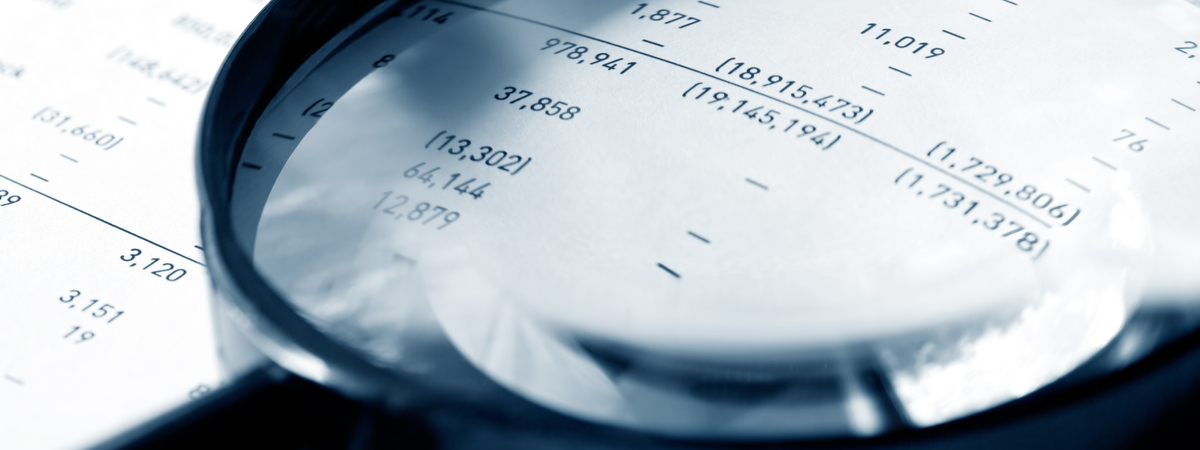 Magnifying glass over financial figures