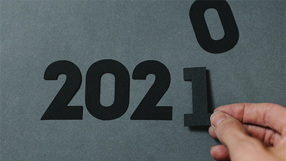 a person's hand replacing a 0 with a 1 in a sequence "202"; image used for blog post about not forgetting about FSAs before end of the year