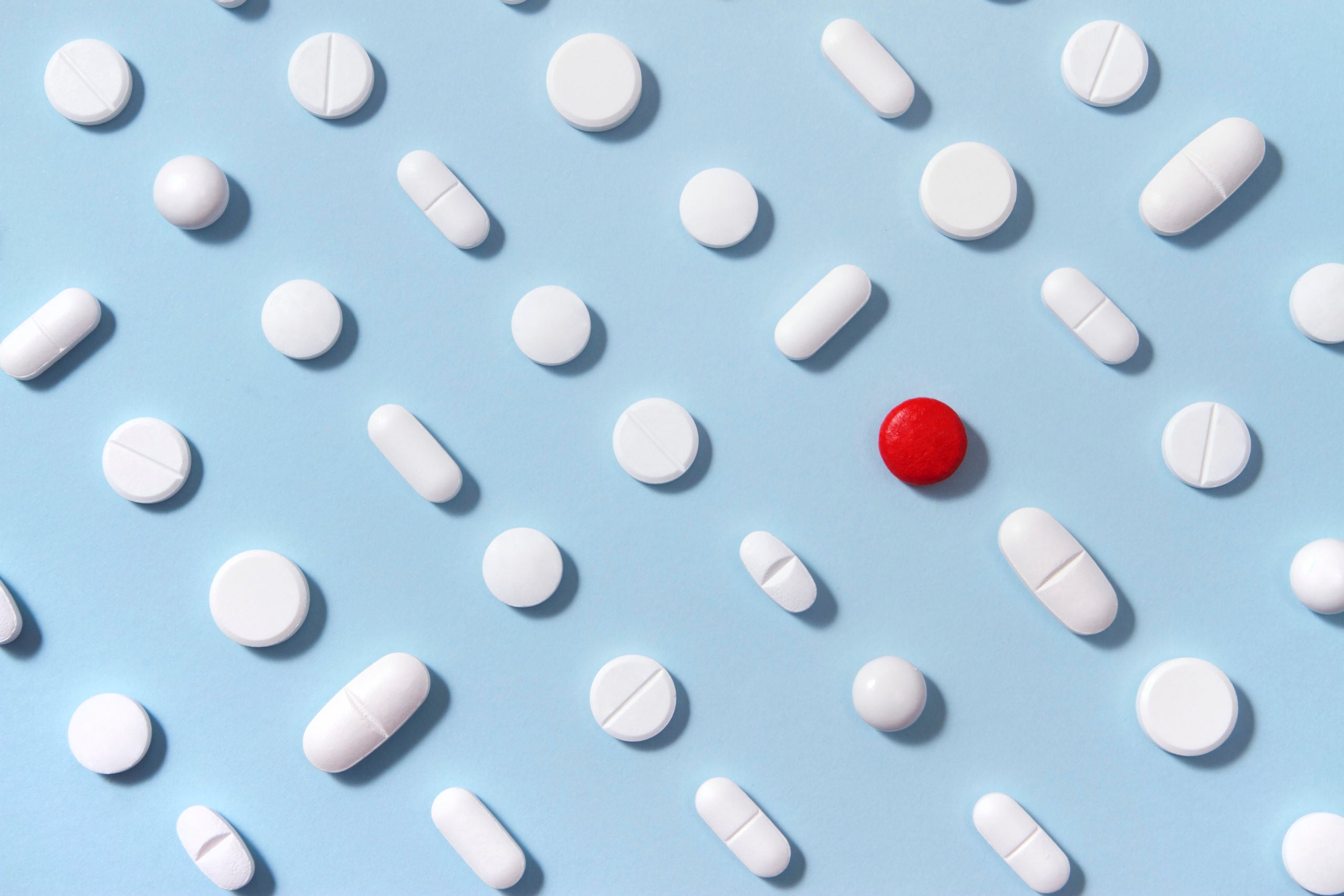 White Pills on Blue Background