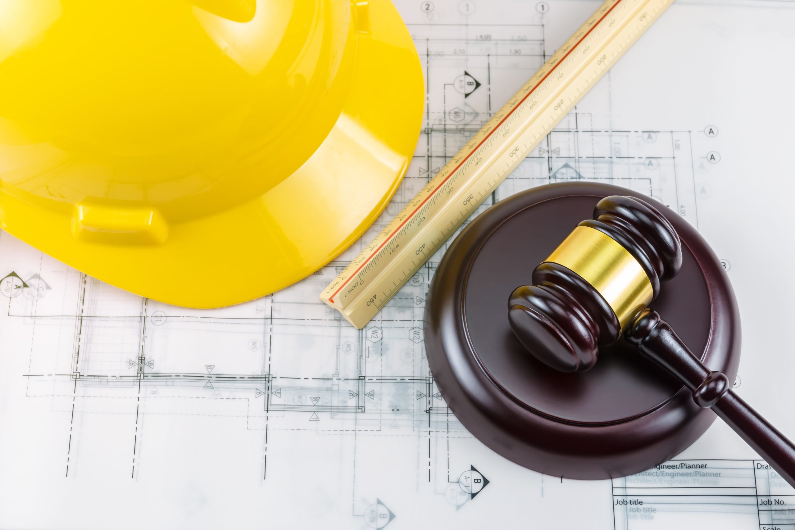 Gavel and yellow safety helmet