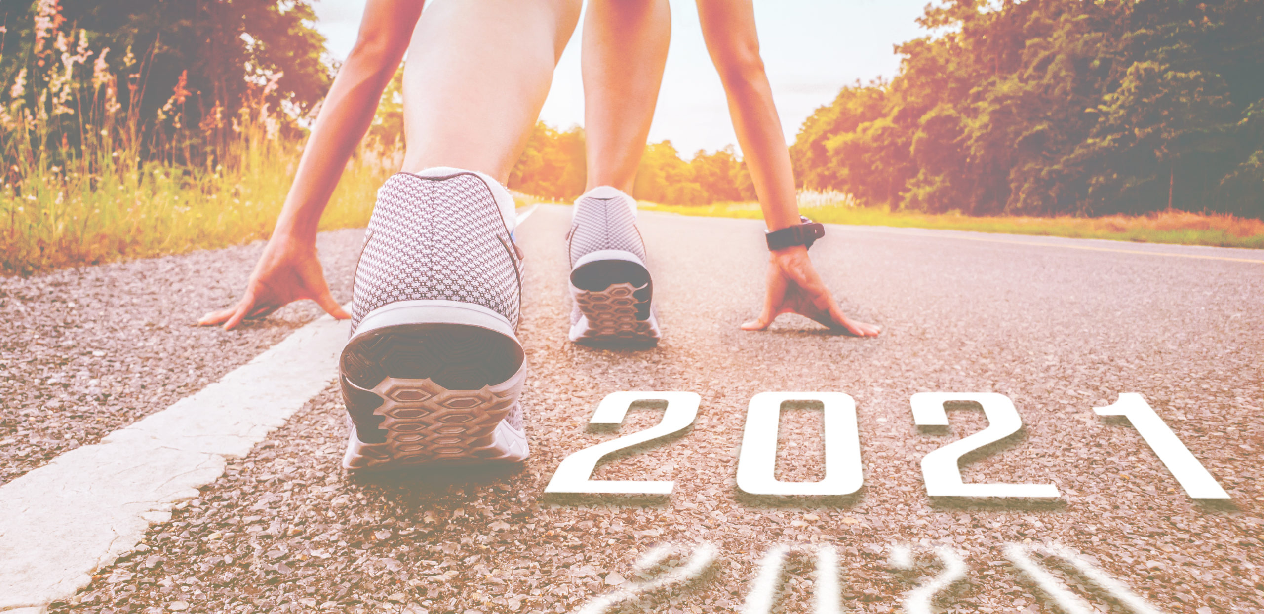 Start 2021 symbolises the start into new year. The start of people running on street is healthy new normal, with sunset light. Goal of Success