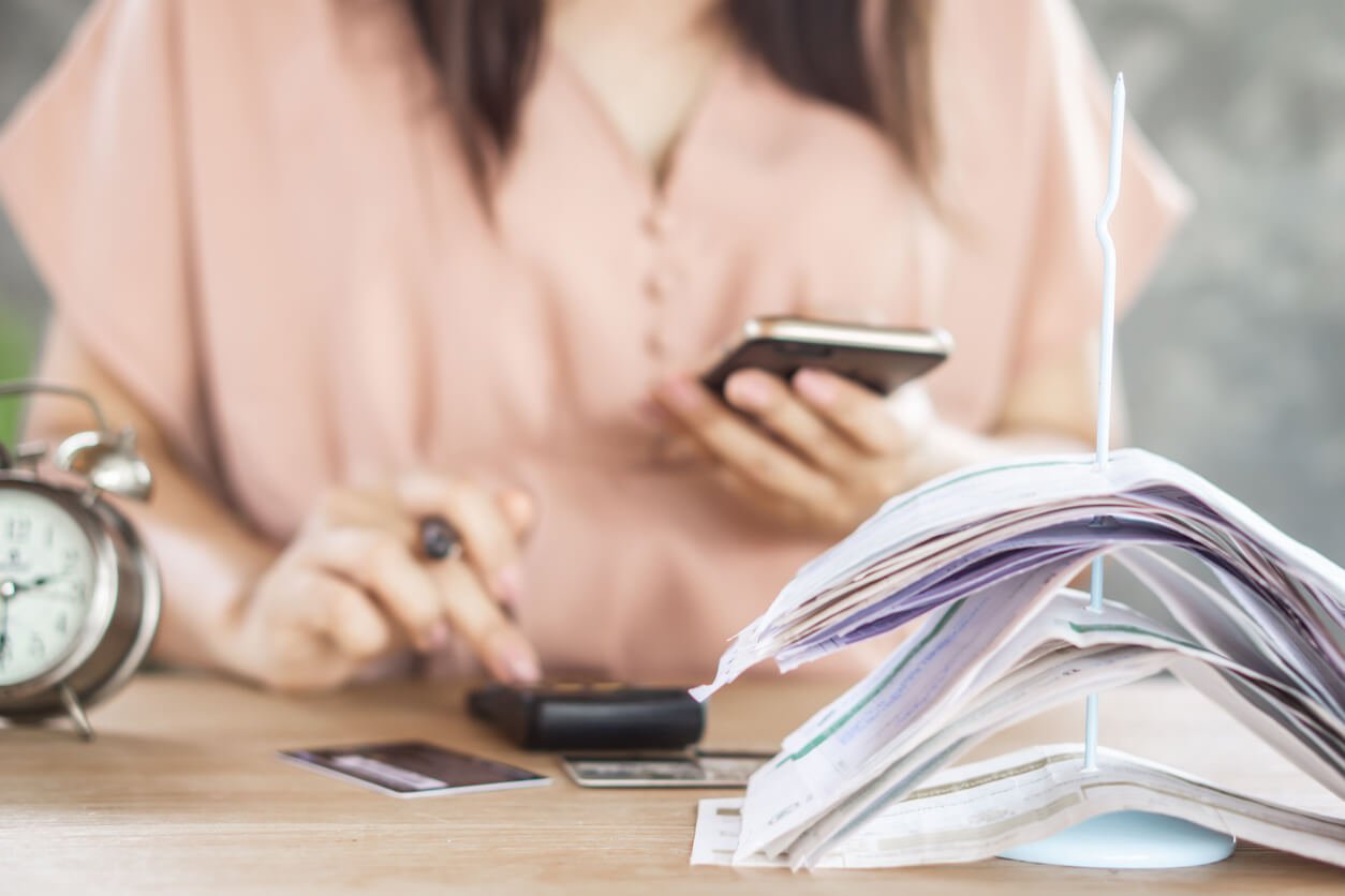 https-www-abclegal-com-hubfs-2021%20blog%20posts-woman-hand-counting-expenses-phone-and-credit-cards-bills-jpg