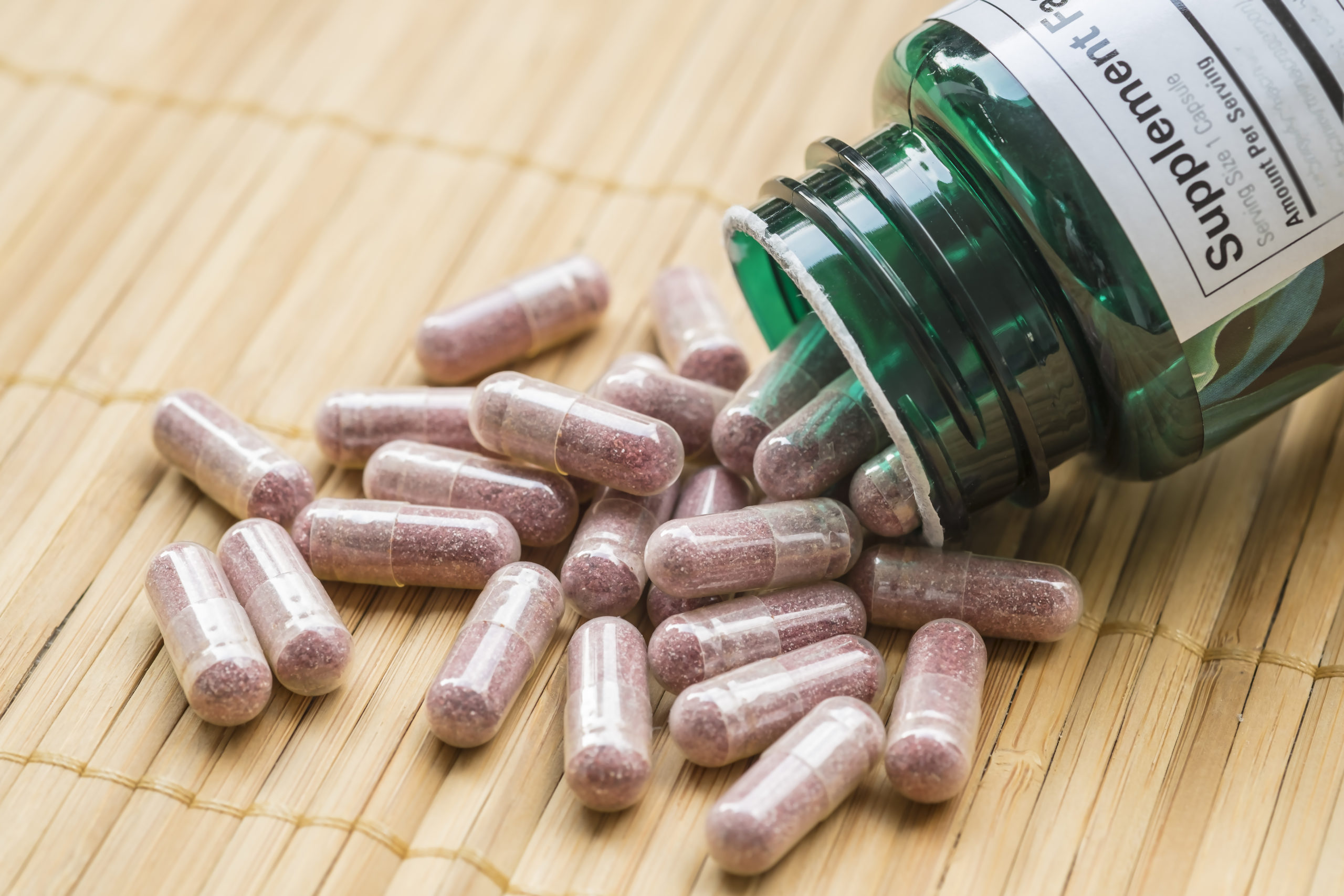 Dietary,Supplement,Capsules,Pouring,Out,Of,Container.
