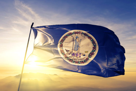 Virginia state of United States flag textile cloth fabric waving on the top sunrise mist fog