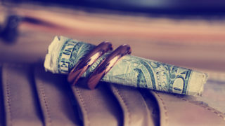 Gold wedding rings so close and a dollar, love and money