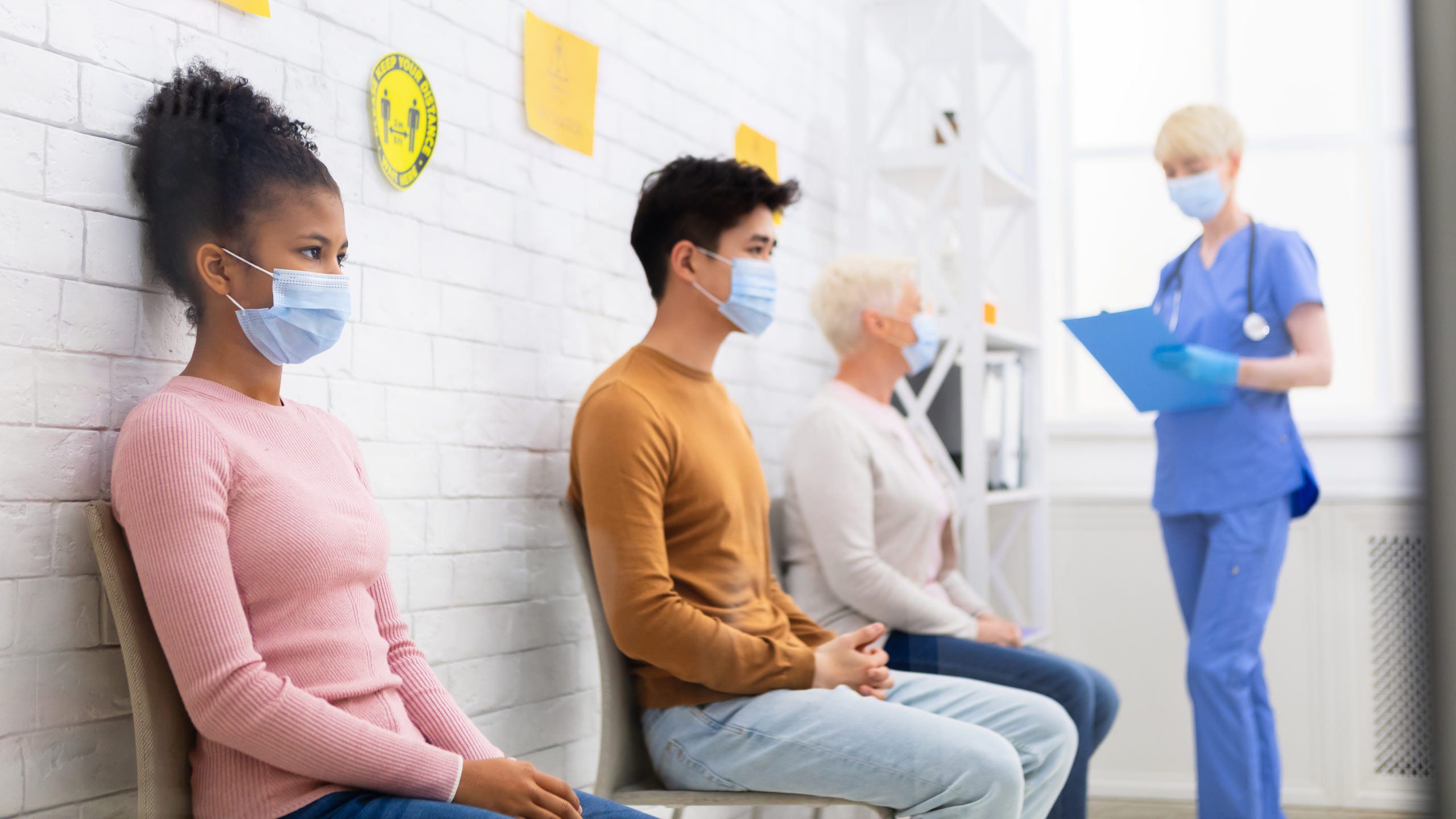 Girl Waiting For Coronavirus Vaccination Sitting In Queue In Hospital