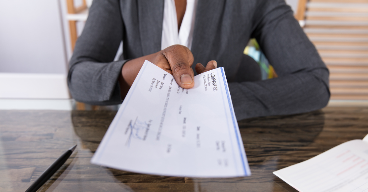 Handing_PayCheck_Over_Desk_1200W