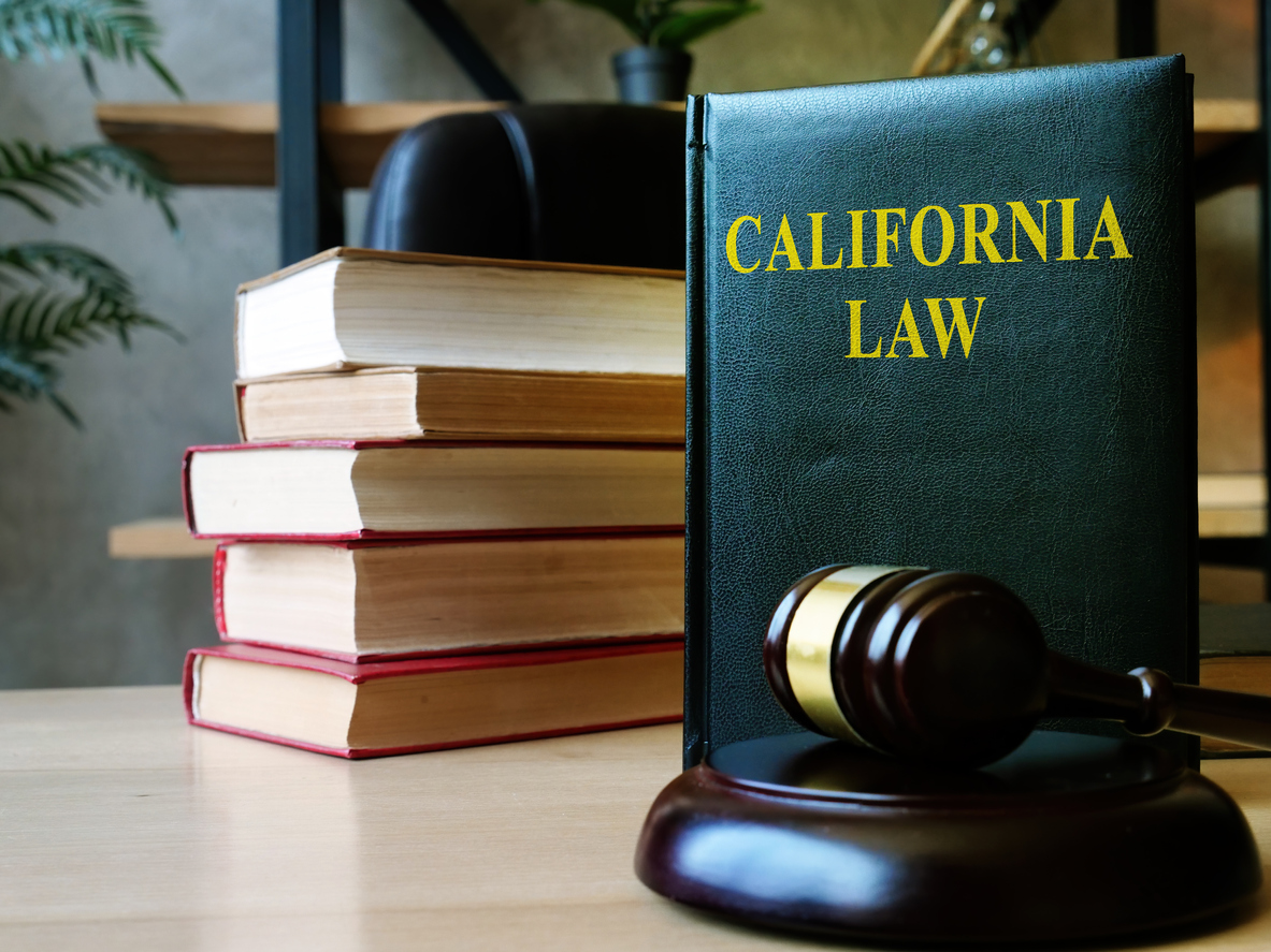 California law with gavel and stack of documents.