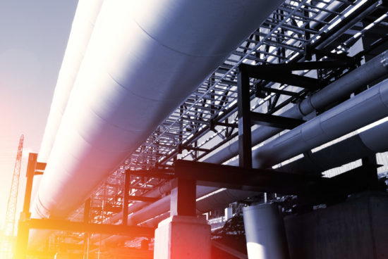 industrial pipelines on pipe-bridge against blue sky