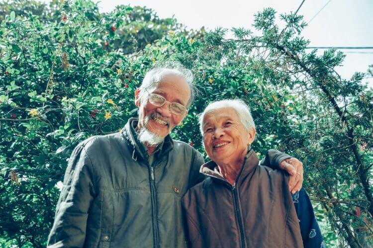 pexels-tristan-le-1642883 elderly couple in front of trees