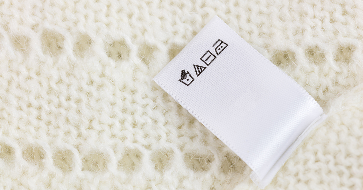 Laundry,Tag,On,White,Knitted,Wool,Sweater,Background,,Big,Size