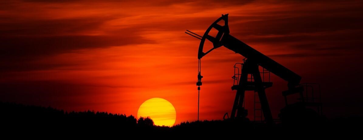 silhouette of an oil rig at sunset