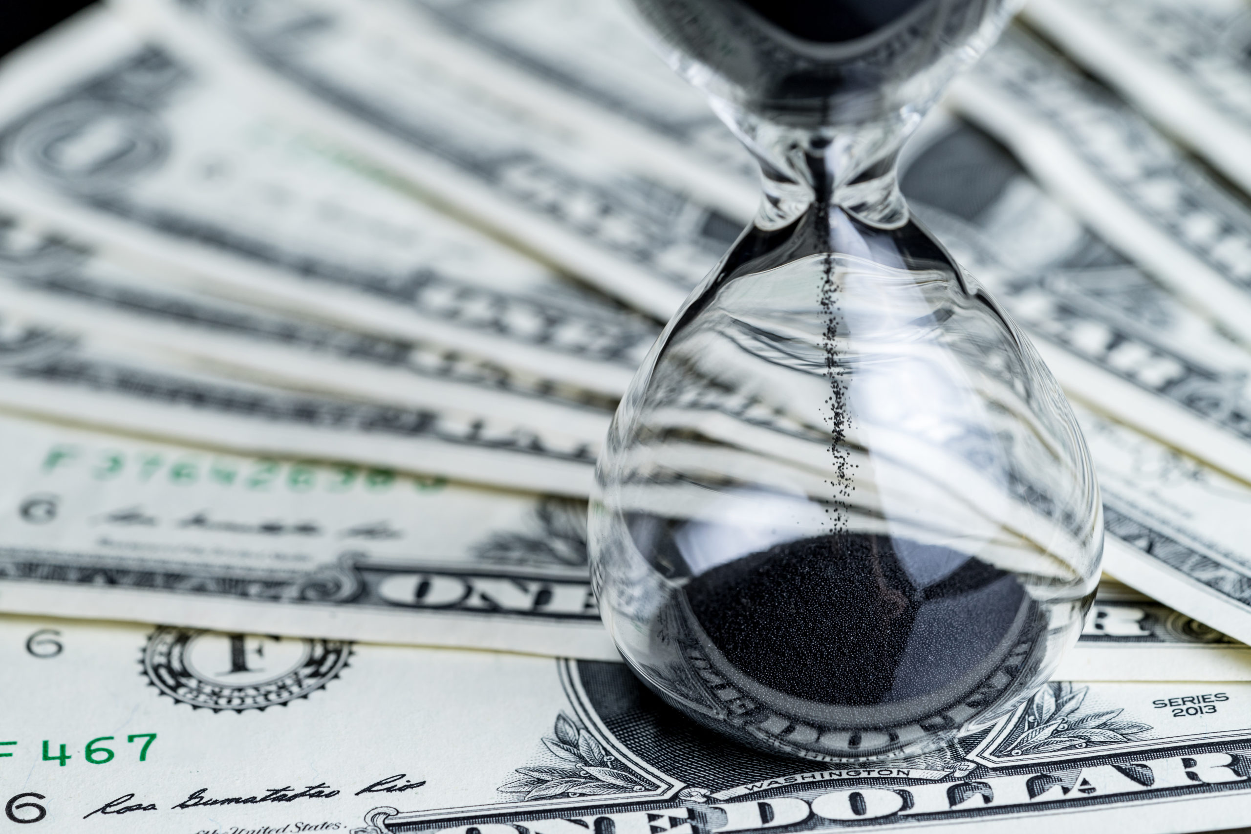Wage hour Hourglass on US dollars - shutterstock_793576108