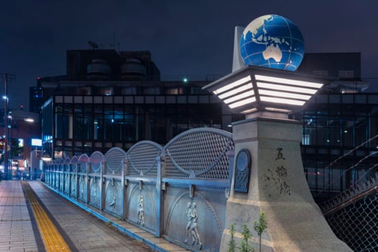 Olympic Bridge or Gorinbashi decorated with an earth globe in Harajuku at night.
