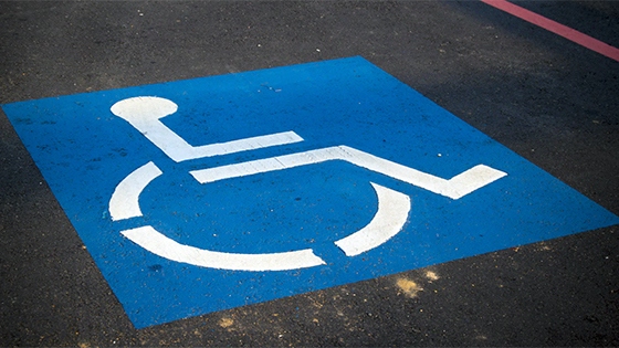 cement with the sign marking of a disabled parking spot; image used for blog post about ABLE accounts helping disabled family members