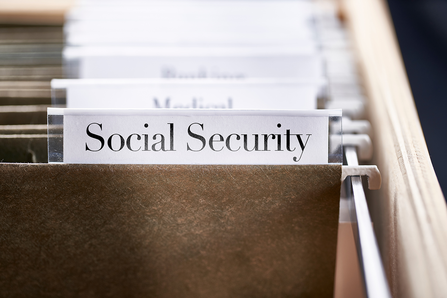 Social Security: Files and folders in desk drawer with labels and tabs: Home office management