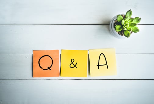Q & A word with paper note on white wood table backgrounds