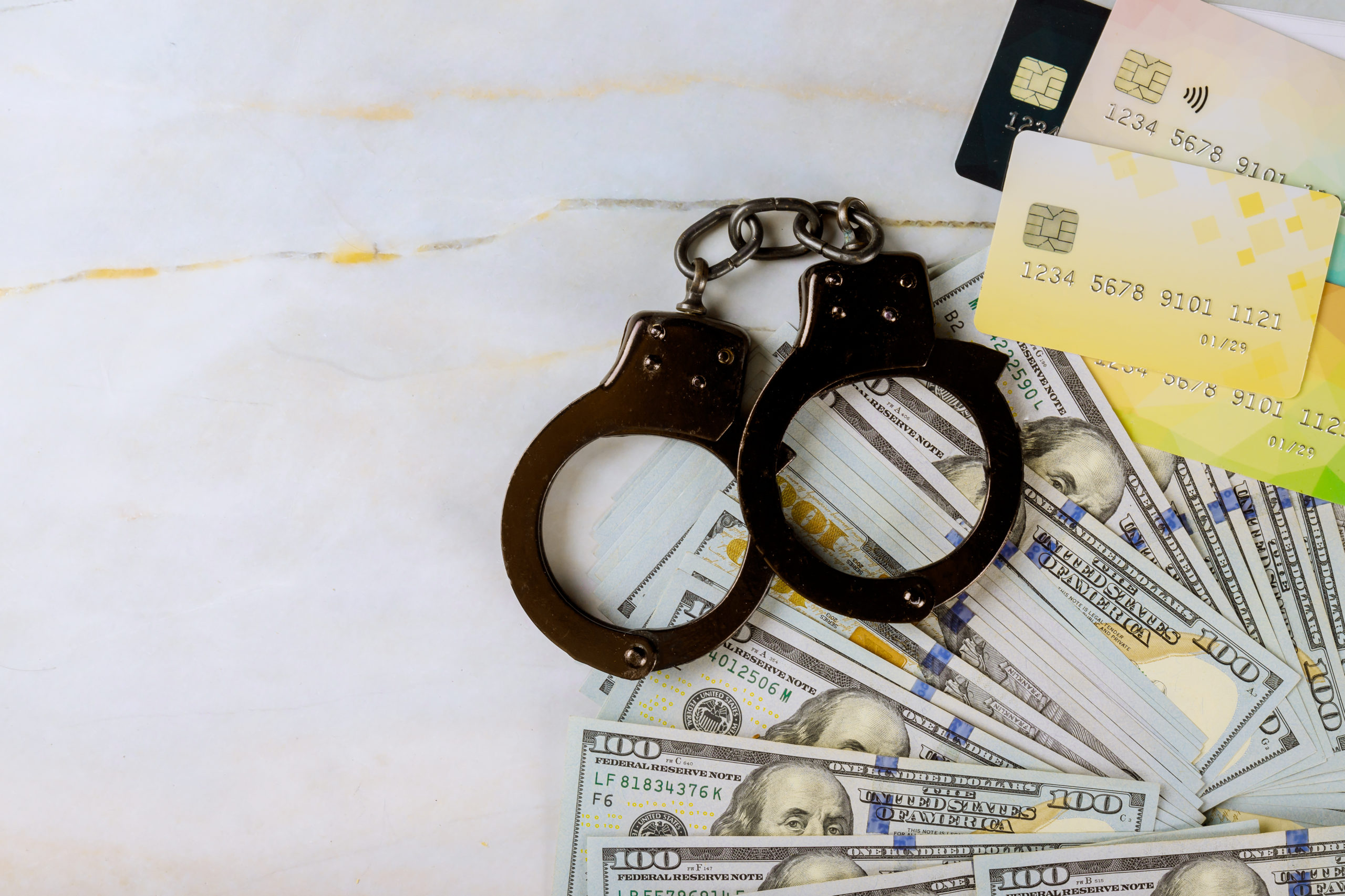 Financial,Crimes,Credit,Cards,And,Dollar,Bills,Handcuffed,Stealing,Credit