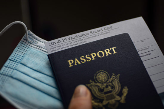 Blurred,Covid-19,Vaccination,Record,Card,,Passport,Of,Usa,And,Medical