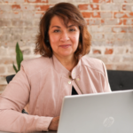Thea Dudley sitting behind a computer