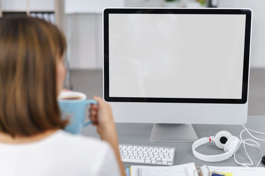 Businesswoman looking at a blank computer screen