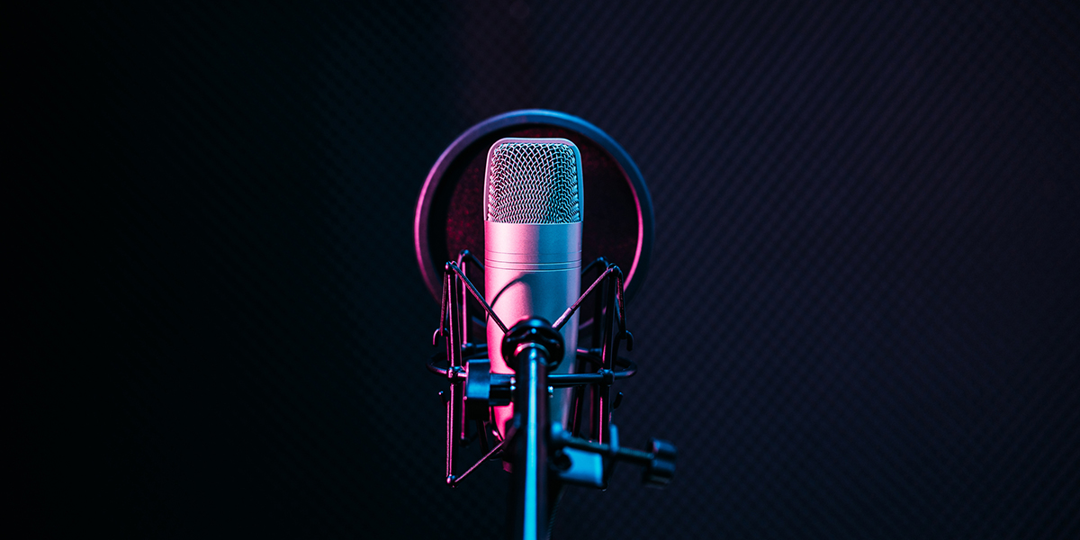 Studio microphone and pop shield on mic in the empty recording studio with copy space. Performance and show in the music business equipment.