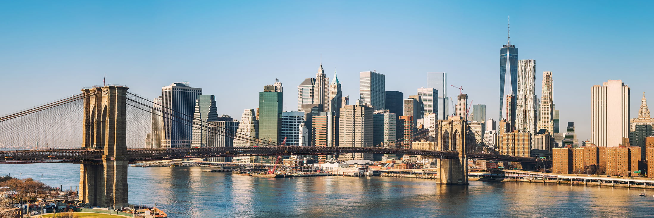 Brooklyn bridge and Manhattan at sunny day