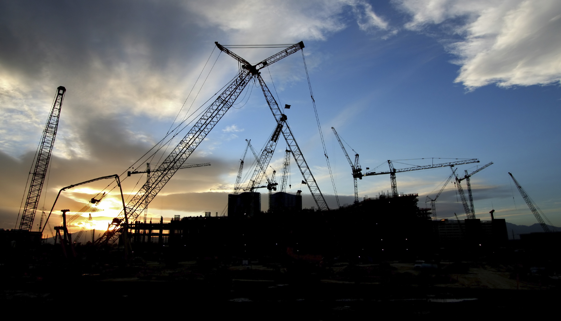 Construction Site Sillouhette with Multiple Cranes at Sunset