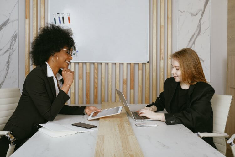 legal operating system A photo of two lawyers sitting across from one another at a table