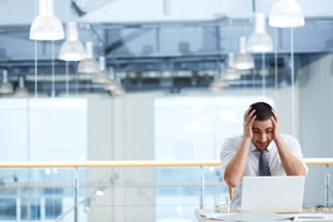man with hands on head in despair representing pro hac vice revocation