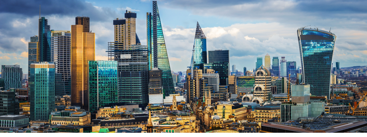 London, England - Panoramic skyline view of Bank and Canary Wharf, central London's leading financial districts with famous skyscrapers at golden hour sunset with blue sky and clouds-shutterstock_1078854536