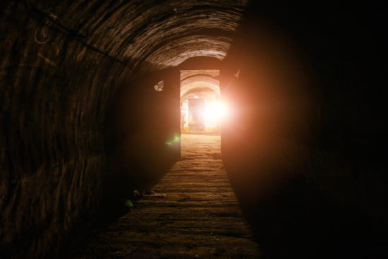 Tunnel with concrete walls in old abandoned Soviet bunker