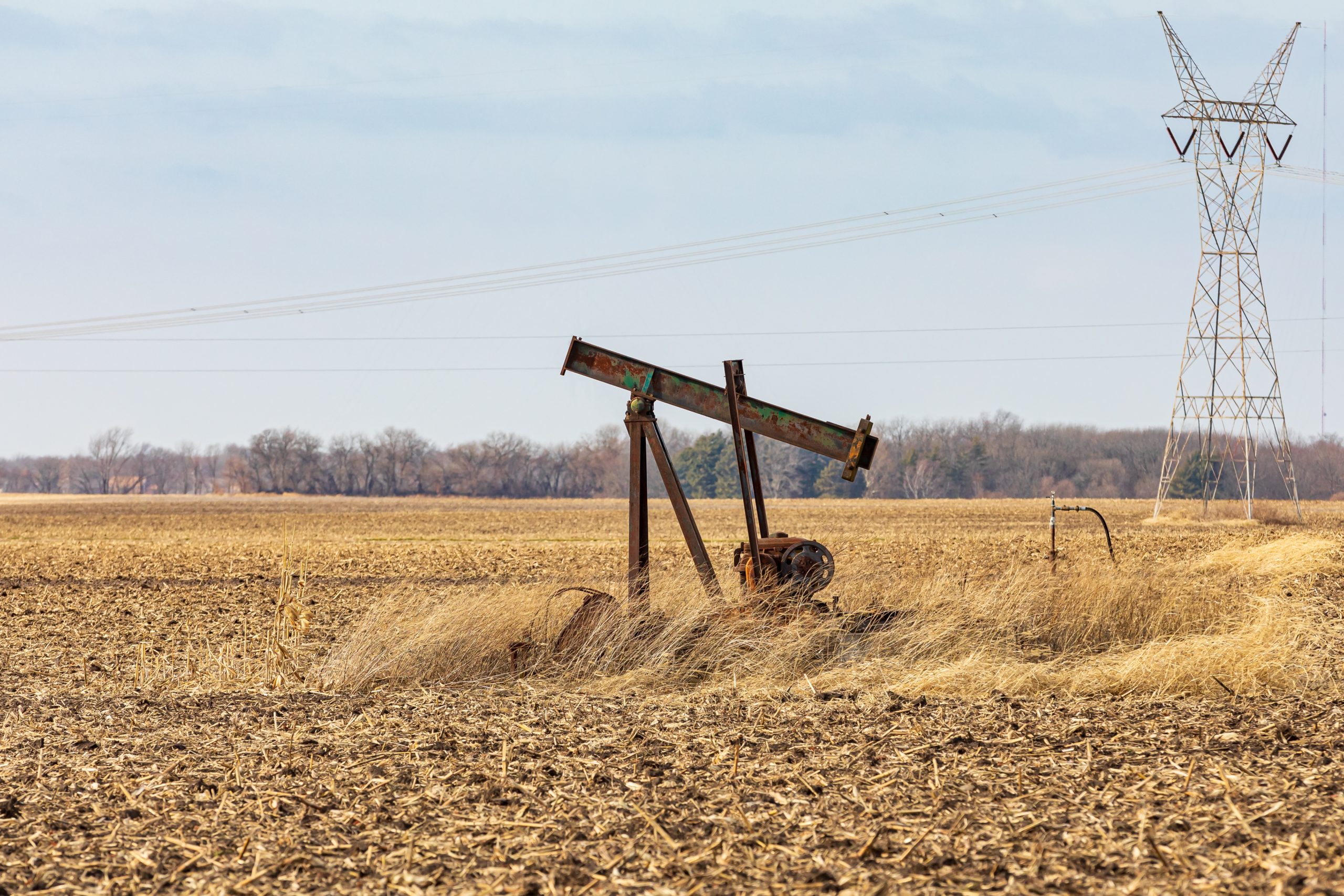 Old,,Orphaned,Oil,Well,Pump,In,Farm,Field.,Oil,Well