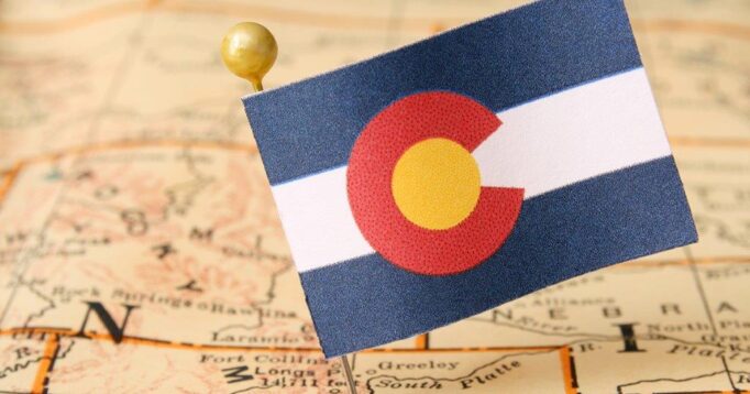Colorado flag against a brown map background