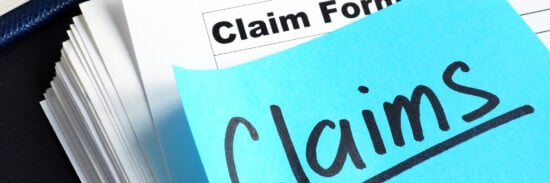 Stack of Claims applications on a desk.